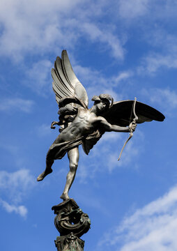 Shaftesbury Memorial Fountain statue of Anteros known as Eros in Piccadilly Circus London against blue sky