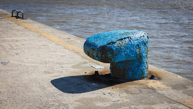 Blue weathered bollard on the Comacchio quay