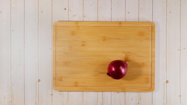 Red Onion Slicing Itself on Cutting Board Flat Lay Stop Motion Animation