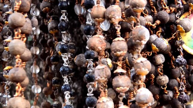 Rudraksha bead chains tied by devotees to a tree in a temple courtyard in Kerala, India