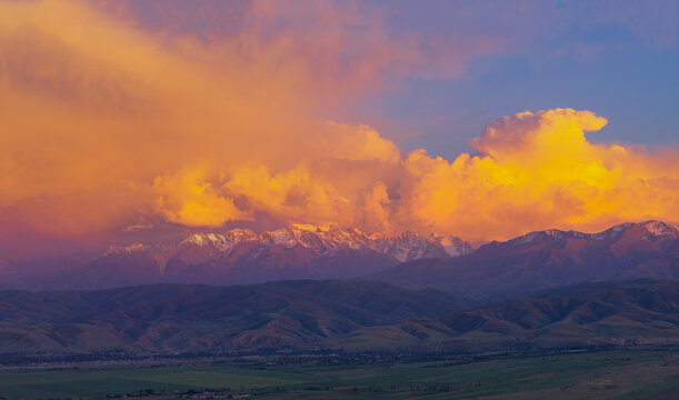 Dramatic Sunset Over Snow-Capped Mountains in Kyrgyzstan
