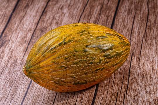 Ripe piel de sapo melon on rustic wooden surface