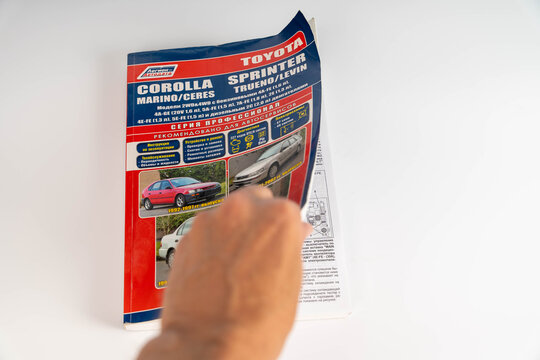 Sosnovy Bor, Russia &mdash; August, 29, 2026: Toyota Corolla Sprinter Trueno Levin brochure held by a person