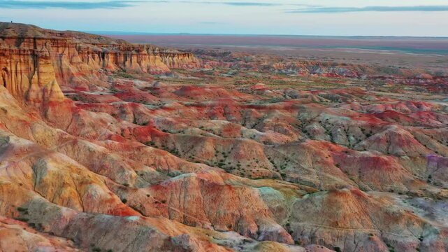 Aerial view of Tsagaan Suvarga featuring colorful sedimentary rock formations and cliffs in the Gobi Desert, O'lziit, Dundgovi, Mongolia.