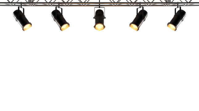 Set of black stage spotlights mounted on a metal truss system lighting up from above as clean cutout