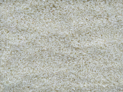 Dry white long grain rice texture background