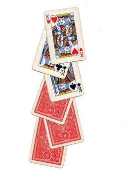 A hand of vintage playing cards isolated on a white background.