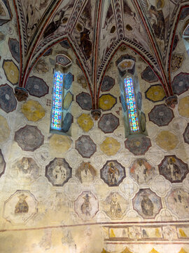 Painted Gothic rib vault with saints' portraits and stained-glass windows inside St. Peter collegiate church, Gers, La Romieu, France