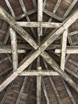 Star-patterned timber roof trusses inside the attic of St. Peter collegiate church, Gers, La Romieu, France