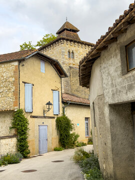 Narrow street leading to the shingled bell tower of the village church, Gers, Sarrant, France