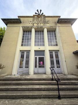 Art Deco facade of the old town hall with 'RF Mairie' lettering and stone steps, Gers, Pavie, France