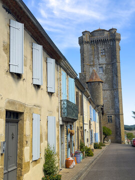 Street of shuttered houses leading toward the medieval chateau tower, Gers, Bassoues, France