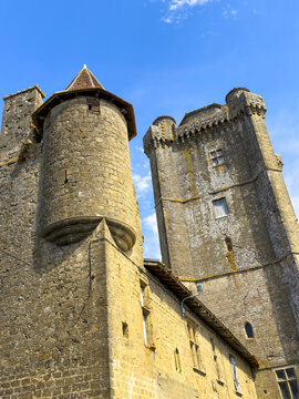 Round turret and square keep of the medieval chateau tower seen from below, Gers, Bassoues, France