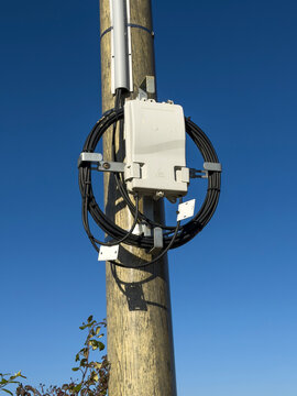 Fiber optic junction box mounted on a wooden utility pole, Gers, Saint Georges, France