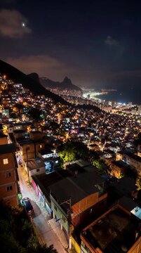Aerial time-lapse of the Rocinha favela hillside transitioning from dusk to sunrise, Rio de Janeiro, Brazil