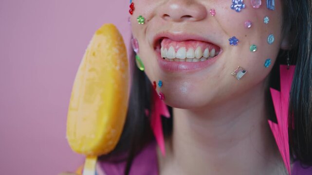 Beautiful asian woman portrait, young asian woman smiling with face stickers and pink background