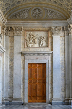The grand portico of the Archbasilica of Saint John Lateran in Rome, Italy, with a view toward the Holy Door and ornate coffered ceiling