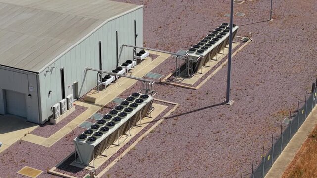 Aerial view of Triton Knoll offshore windfarm 400220kV substation with industrial cooling fans and gravel grounds in Boston, England, United Kingdom.