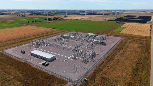 Aerial view of the Triton Knoll offshore windfarm 400220kV substation surrounded by agricultural fields and wind turbines in Boston, England, United Kingdom.
