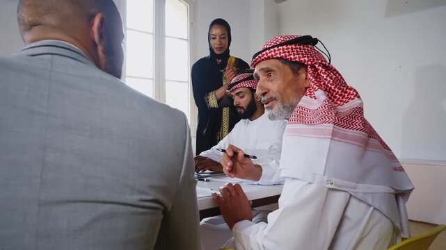 Business professionals discussing project during international office meeting