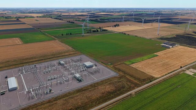 Aerial view of the Triton Knoll offshore windfarm substation surrounded by agricultural fields and wind turbines in Boston, England, United Kingdom.
