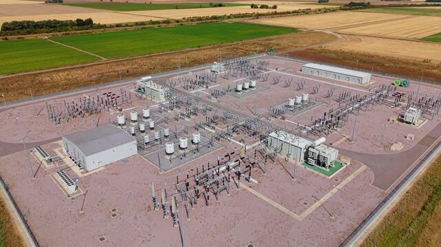 Aerial view of the Triton Knoll offshore windfarm 400220kV substation with electrical infrastructure and surrounding fields in Boston, England, United Kingdom.