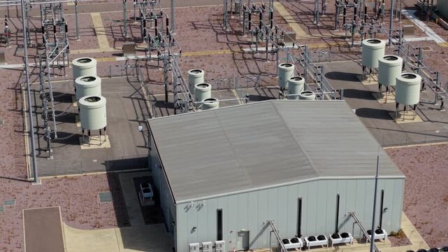 Aerial view of the Triton Knoll offshore windfarm 400220kV substation featuring industrial electrical equipment, cooling units, and metal structures in Boston, England, United Kingdom.