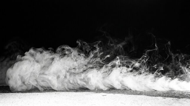 Dramatic White Smoke or Fog Rolling Across Dark Ground Background