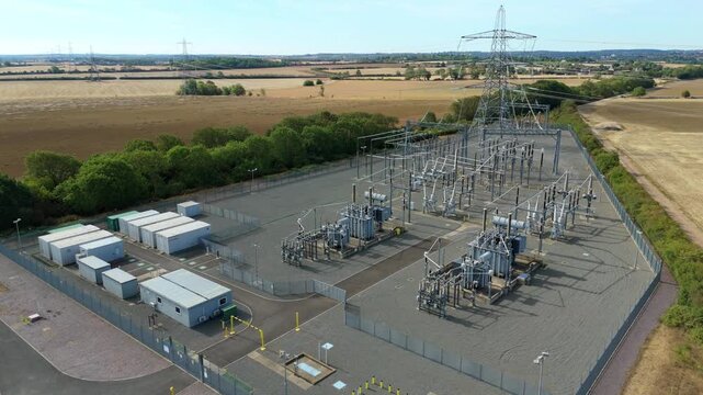Aerial view of the National Grid Ryhall Substation featuring 400kV air cooled transformers and electrical infrastructure in Ryhall, England, United Kingdom.