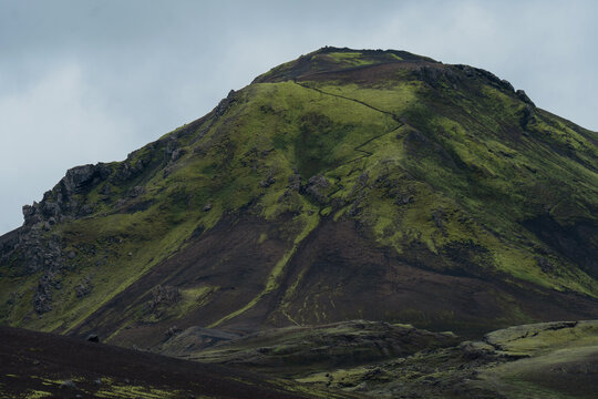 Volcanic hill covered in neon green moss in Iceland in Highlands 