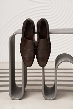 Elegant brown shoes resting on modern bench design
