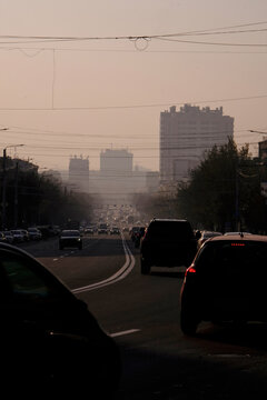 Cars Are Driving Through The City in A Haze.