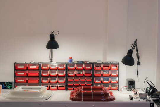 Workbench with product prototypes under lamps