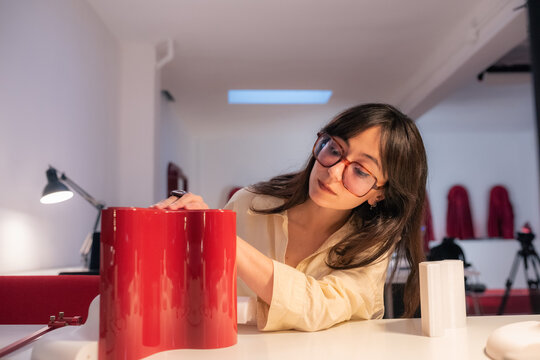 Woman working with 3d object at office