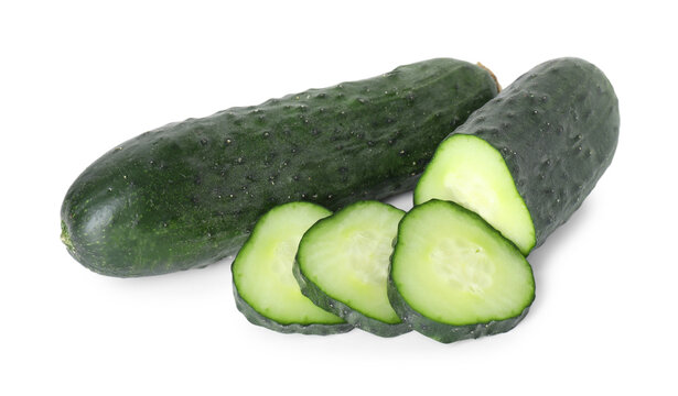 Whole and cut fresh cucumbers isolated on white