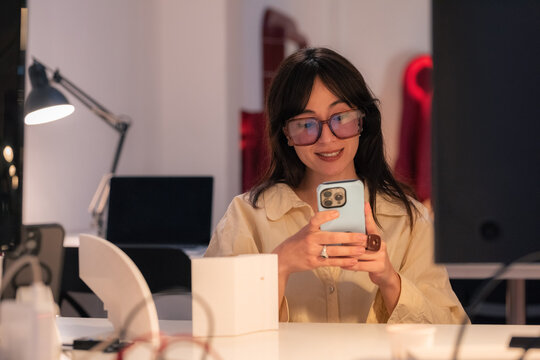 Woman using smartphone at work