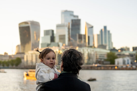 Father And Baby Admiring London's Financial District