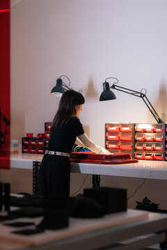 Woman assembling product at design manufacture