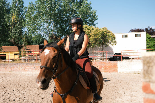 Cheerful horsewoman riding outdoors