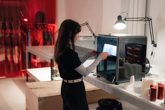 Woman using 3d printer at studio