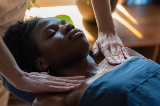 Therapist massaging chest of woman