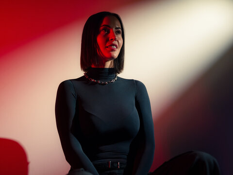 Model posing in studio in red light