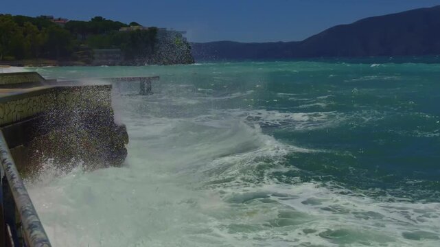 Powerful Sea Waves Crashing Against Coastal Concrete Embankment Pier Wall With Water Splashes And White Foam. Sea Stormy Weather 