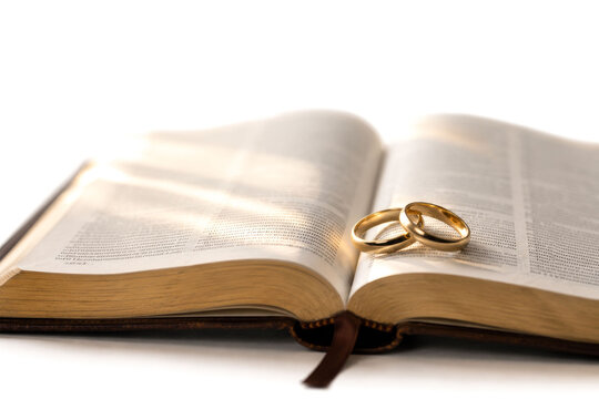 Gold Wedding Rings on Open Bible &ndash; Christian Marriage and Fidelity