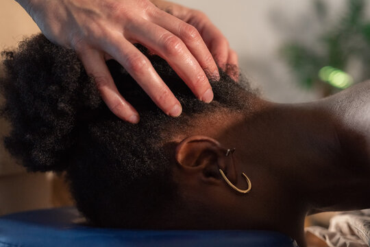 Woman receiving neck and head massage