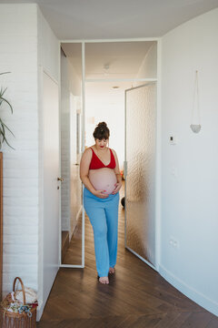 Pregnant woman standing at home