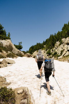 UGC Two men climbing snowy summer slope in the Pyrenees