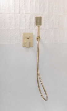 Gold handheld shower fixture detail