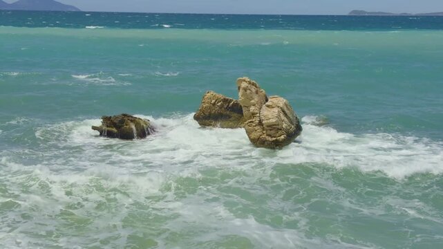 Sea Waves Breaking With White Foam Around Coastal Rocks In Turquoise Water. Scenic Mediterranean Marine Coastline 