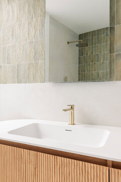 Fluted vanity with brass faucet